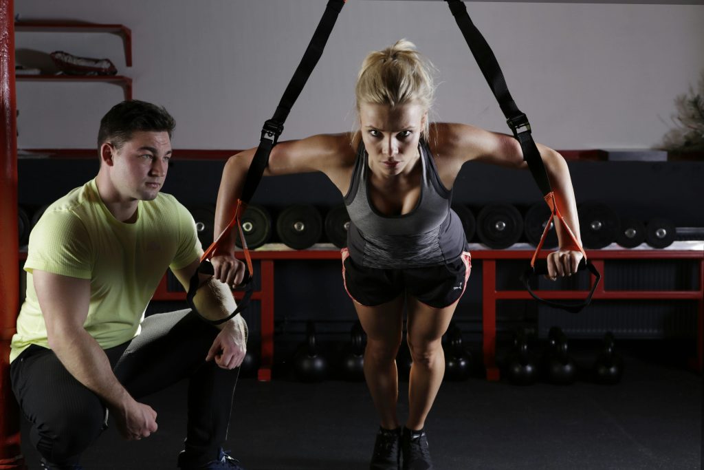 A person performing a barbell squat, a key compound lift exercise.